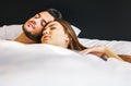 Loving young couple sleeping together in a bed with white sheets at home - Life`s moments of people in love in the bedroom Royalty Free Stock Photo