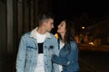 Loving young couple walking on the street. Young couple on an evening romantic date. Night city on the background Royalty Free Stock Photo