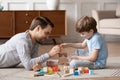 Young dad play with building bricks with small son Royalty Free Stock Photo