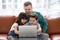 Happy father have fun using laptop with little kids Royalty Free Stock Photo