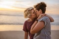 Loving young lesbian couple kissing on a beach at sunset Royalty Free Stock Photo