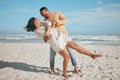 Loving young mixed race couple dancing on the beach. Happy young man and woman in love enjoying romantic moment while on Royalty Free Stock Photo