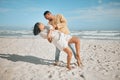 Loving young mixed race couple dancing on the beach. Happy young man and woman in love enjoying romantic moment while on Royalty Free Stock Photo