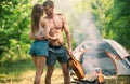 Loving young sexy coupl near camp tent. Camping couple in love. Couples of lovers tourists relax on nature. Camping trip Royalty Free Stock Photo