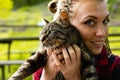 Loving young woman cuddling her cat to her cheek Royalty Free Stock Photo