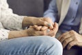 Loving young woman holding her senior mother& x27;s hand comforting and supporting her Royalty Free Stock Photo