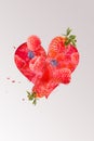 Lovingly designed heart photomontage with raspberries, blackberries, strawberries and water splashes in the background