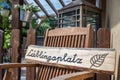 Self-carved wooden sign with the word favorite place in german language in front of a cozy terrace Royalty Free Stock Photo