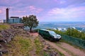 Lovos, Czech republic - July 05, 2017: green jeep Nissan on top hill Lovos next to tourist cottage with view to Pistany lake, Rado