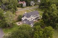 Low aerial view of beautiful residential home on large wooded property