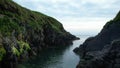 Low altitude flight above water between 2 cliffs leading up to the sea in Dundeady Island near Rosscarbery, Cork, Ireland