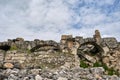 Low angle ancient greek ruins and remainings in greek theatre side.