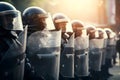 Low angle of anonymous police soldiers in protective uniforms and helmets standing against squad van and defending by