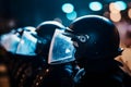 Low angle of anonymous police soldiers in protective uniforms and helmets standing against squad van and defending by