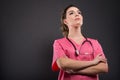 Low angle of attractive lady doctor posing with arms crossed Royalty Free Stock Photo