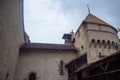 Low angle of beautiful tower in chateau de chillon, castle in Montreux Switzerland, on cloudy sky background