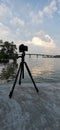 Low Angle of a Camera on a Tripod Next to a River in Thailand. Royalty Free Stock Photo