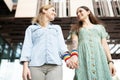 Young girlfriends holding hands with rainbow bracelets Royalty Free Stock Photo