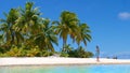 LOW ANGLE: Caucasian girl on a scenic stroll along lush tropical sandy shoreline Royalty Free Stock Photo