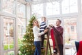 Happy family near Christmas tree at home