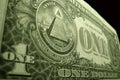 Low angle close up of the American dollar, focused on the eye of providence, at the top of the pyramid.