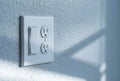 Close-Up Of Modern White Light Switch And Electrical Outlet On Textured Wall Royalty Free Stock Photo