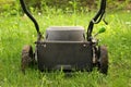 Low Angle Close up lawnmower ready to be cutting long grass or illustrating concept of helping bees Royalty Free Stock Photo