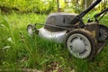 Low Angle Close up lawnmower ready to be cutting long grass or illustrating concept of helping bees Royalty Free Stock Photo