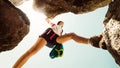 Low angle close up one young caucasian sporty woman alone train rock climb outdoors in sunny hot weather alone. Inspirational