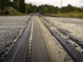 Low angle close up photo of a railroad track crossing a country road Royalty Free Stock Photo