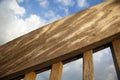 Wooden Banister & Blue Cloudy Sky