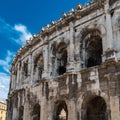 Low-angle closeup of Amphitheatre of Nimes against sunlit, clear sky background Royalty Free Stock Photo