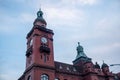 Low-angle closeup of a Rathaus Pankow against cloudy sky background