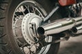 Low angle closeup of rear tire and exhaust of chopper motorbike Royalty Free Stock Photo