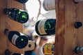 Low angle closeup shot of bottles of champagne hanged on pieces of wood in the Hvar city of Croatia Royalty Free Stock Photo