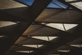 Low angle closeup shot of a ceiling with wooden beams and glass skylight windows Royalty Free Stock Photo