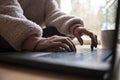 Low angle closeup view of female hands typing and using laptop computer Royalty Free Stock Photo