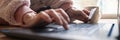 Low angle closeup view of female hands using laptop computer and holding a credit card Royalty Free Stock Photo