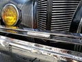 Low angle closeup view of the headlights of an old vintage car Royalty Free Stock Photo