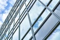 Low angle, construction and building with glass windows in city for business, office and commercial property with sky Royalty Free Stock Photo