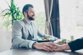 Low angle cropped photo of couple, having lunch together, holding hands, so romantic! Having salads, enjoying, in a fancy nice te Royalty Free Stock Photo