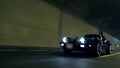 Low angle diagonal shot of Corvette driving through the tunnel