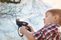 Low angle of a diligent little boy pruning the tree Royalty Free Stock Photo