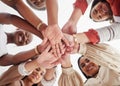 Low angle diverse group of ambitious smiling businesswomen huddled together with hands stacked in middle. Smiling ethnic Royalty Free Stock Photo