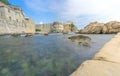 Low Angle of Dubrovnik's City Walls with Sunbathers Royalty Free Stock Photo