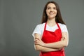 Low angle of female supermarket employee standing with arms crossed