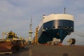 Low angle front view of a large Auto car carrier ship moored alongside in port