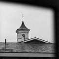 Low angle grayscale shot of a church with a cross on top Royalty Free Stock Photo