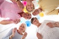 Angle of happy senior friends in the circle with balloons during birthday party Royalty Free Stock Photo