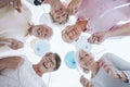 Low angle of happy senior people in the circle with balloons Royalty Free Stock Photo